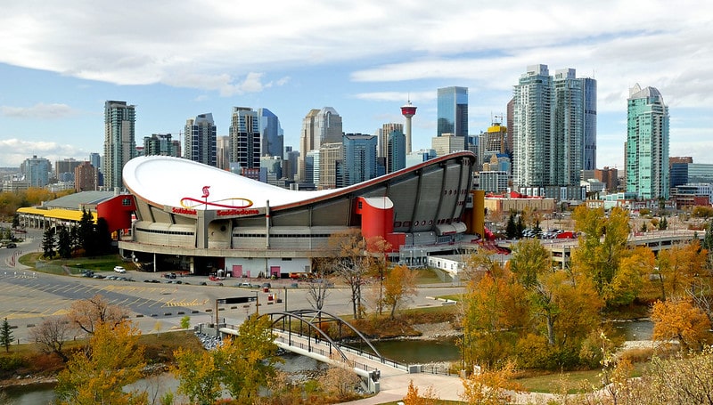 View of the Scotiabank Saddledome with  the city of Calgary behind it.